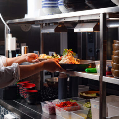 Chef crafting modern Thai cuisine in the open kitchen