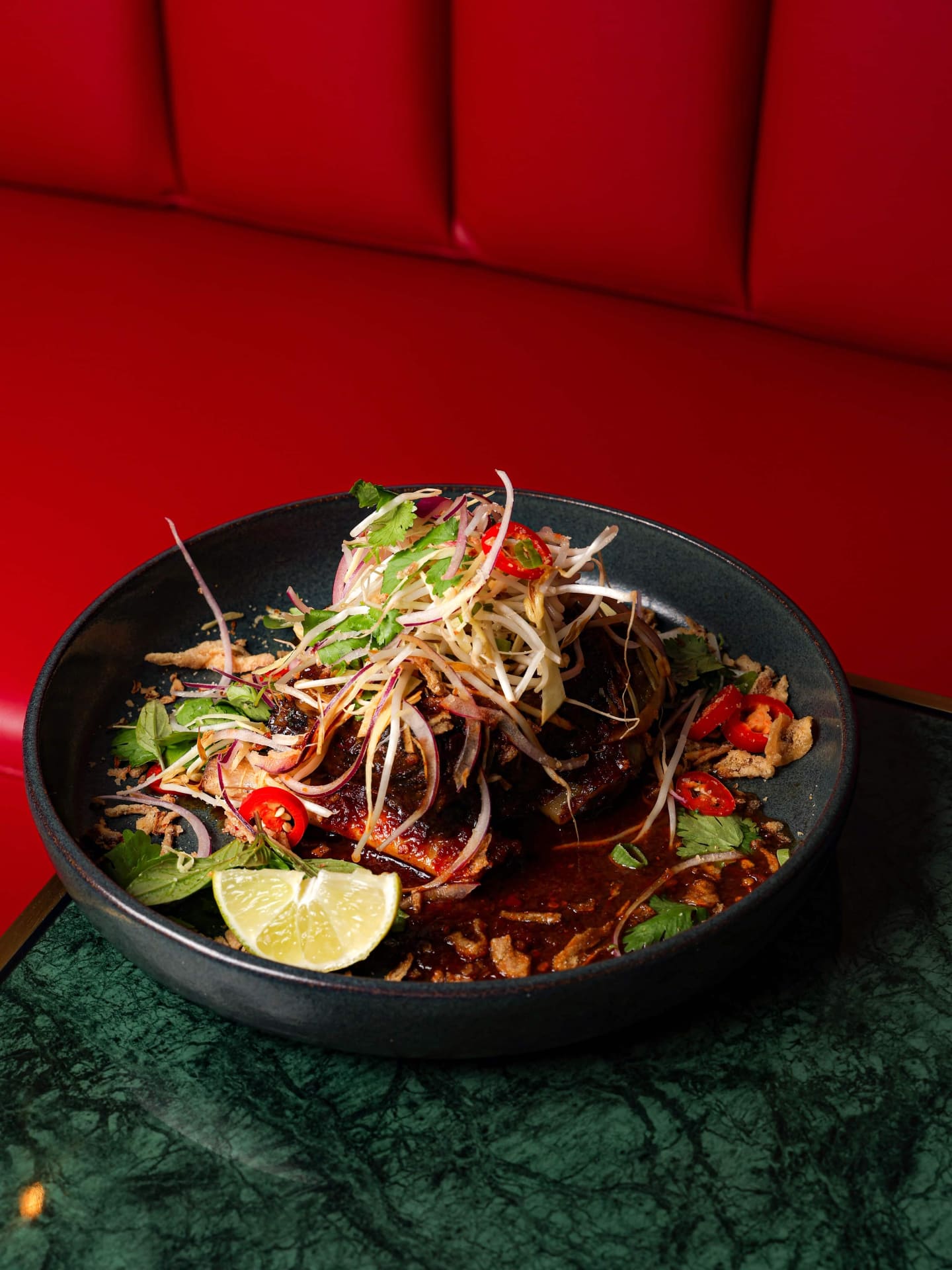 A spicy salad on the red banquette