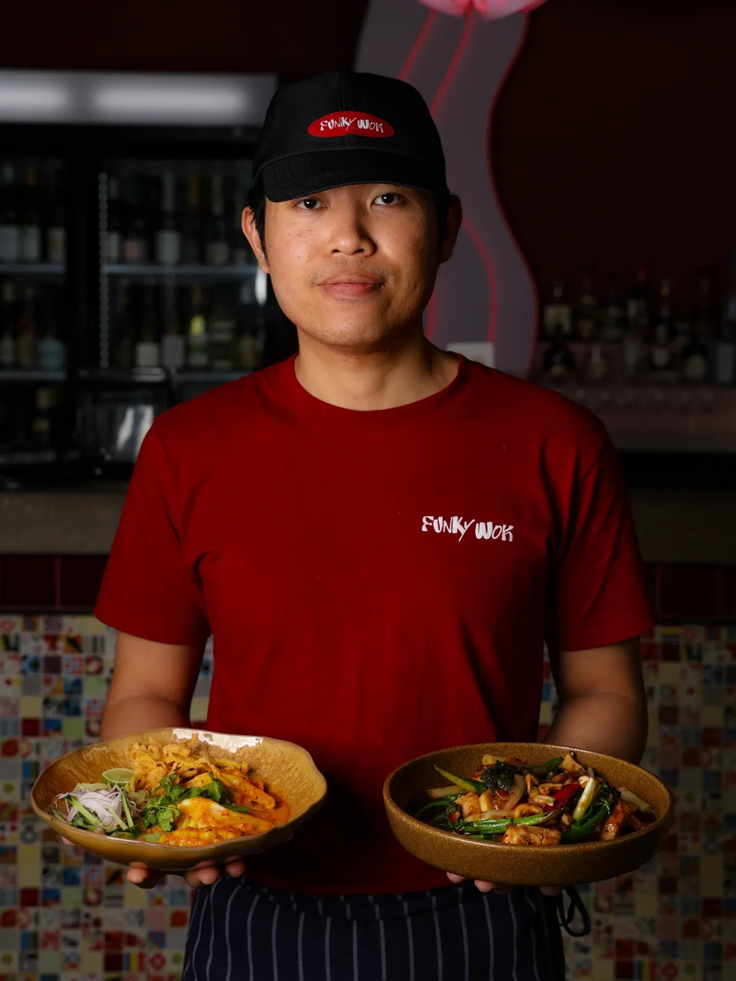 A team member carrying two dishes