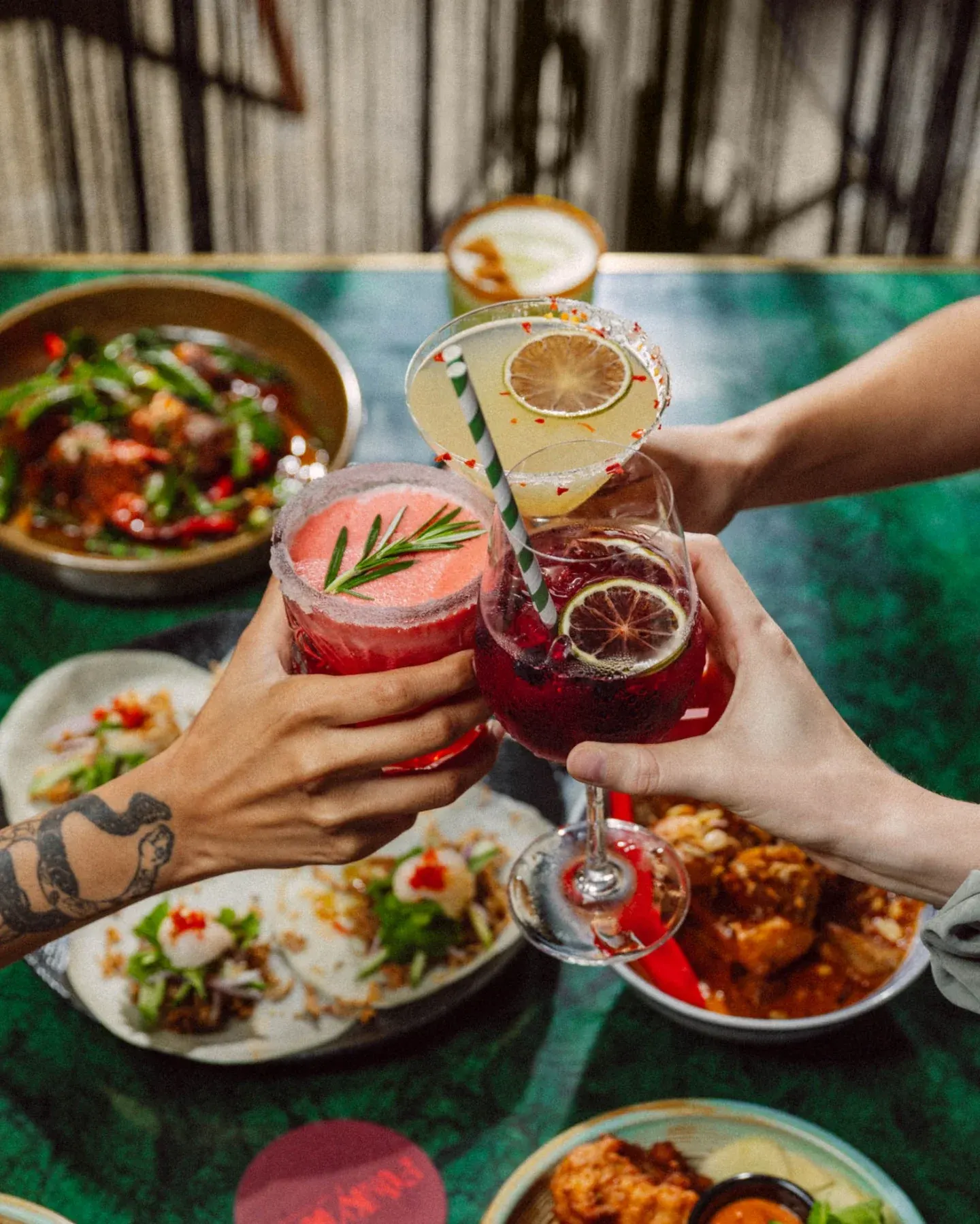 Cocktails over a spread of dishes